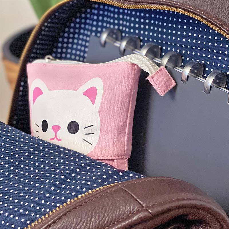 Putting a pink pencil case away inside a school backpack